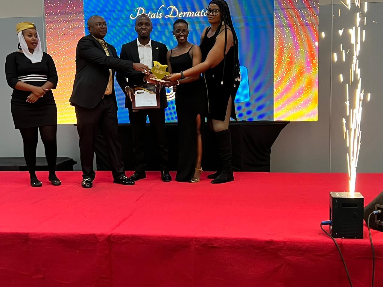 The Petals Dermatology team receiving the 2026 award on stage